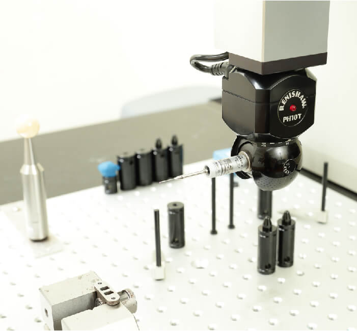 Renishaw PH10T motorised indexing probe head on a coordinate measuring machine table with fixturing
